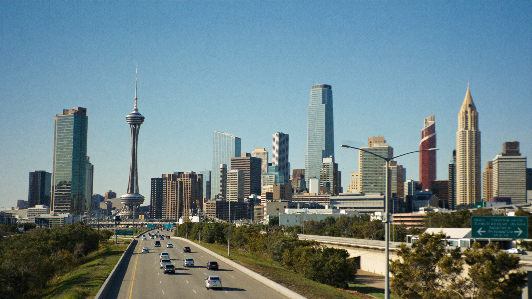 Downtown San Antonio skyline seen from a Texas highway approach during a weekday commute